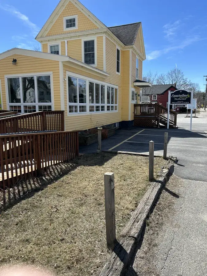 Residential window cleaning on a charming yellow colonial